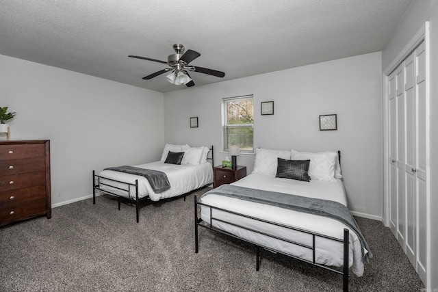 carpeted bedroom featuring ceiling fan, a textured ceiling, and a closet