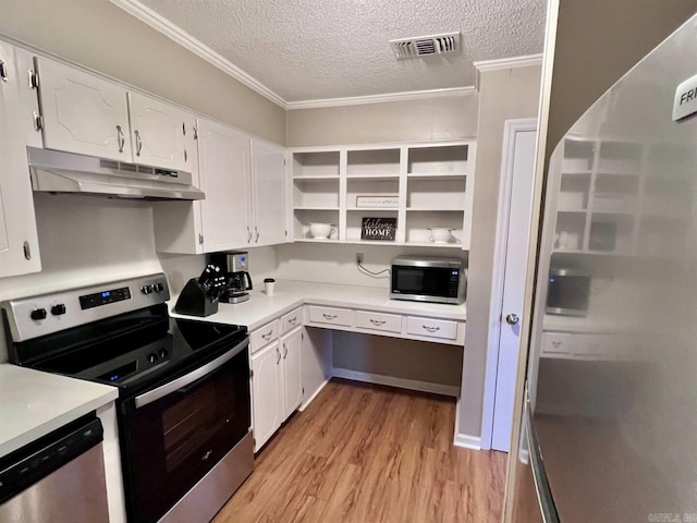 kitchen with white cabinets, light wood-type flooring, stainless steel appliances, and a textured ceiling