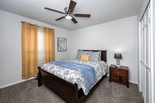 bedroom featuring ceiling fan, a closet, a textured ceiling, and dark colored carpet