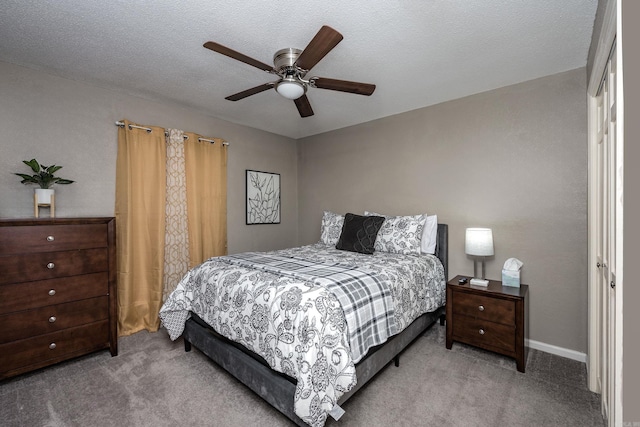 carpeted bedroom with a textured ceiling and ceiling fan