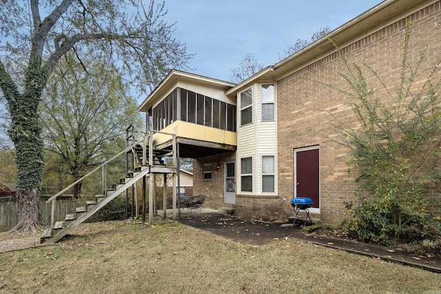 rear view of house featuring a patio and a sunroom