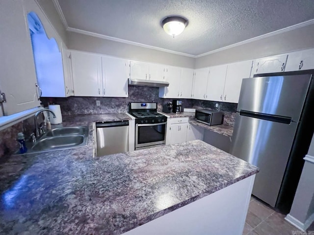 kitchen featuring decorative backsplash, white cabinetry, sink, and appliances with stainless steel finishes