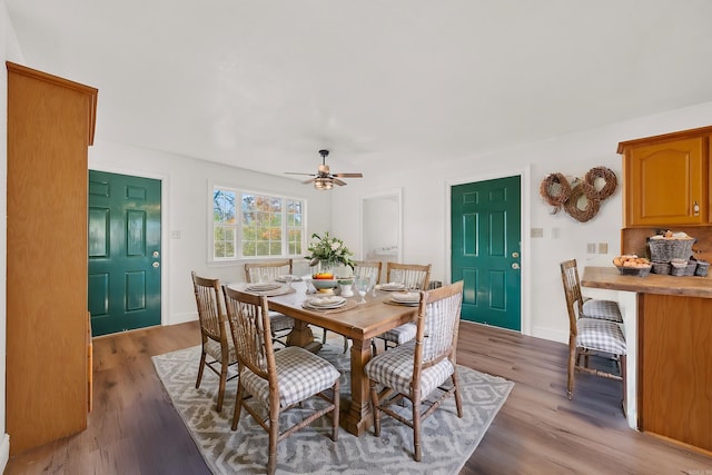 dining room with light hardwood / wood-style flooring and ceiling fan