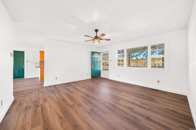 spare room featuring dark hardwood / wood-style flooring and ceiling fan