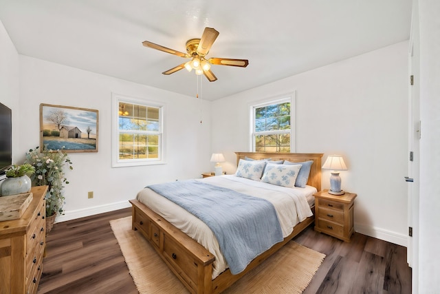 bedroom with dark hardwood / wood-style flooring and ceiling fan