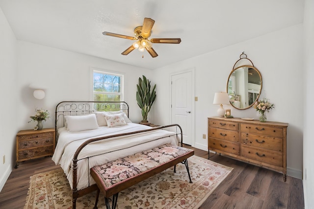 bedroom with dark hardwood / wood-style flooring and ceiling fan