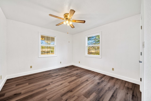 spare room featuring ceiling fan, dark hardwood / wood-style flooring, and a textured ceiling