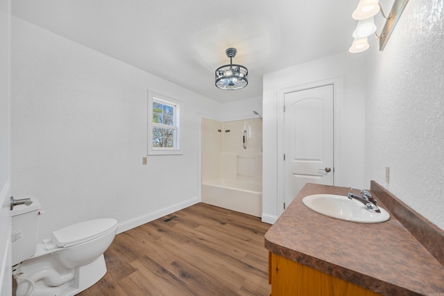 full bathroom with hardwood / wood-style floors, vanity, toilet, and shower / tub combination