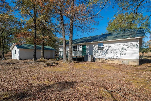 rear view of house featuring a deck