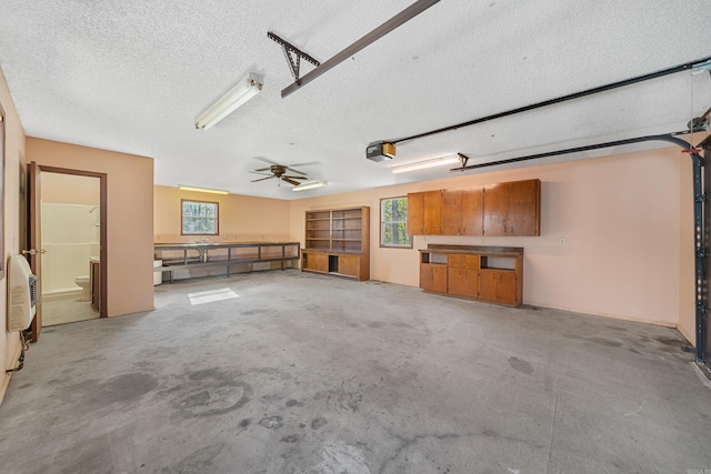 garage featuring ceiling fan and a garage door opener