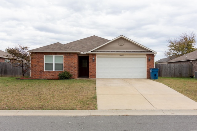 ranch-style house featuring a garage and a front yard