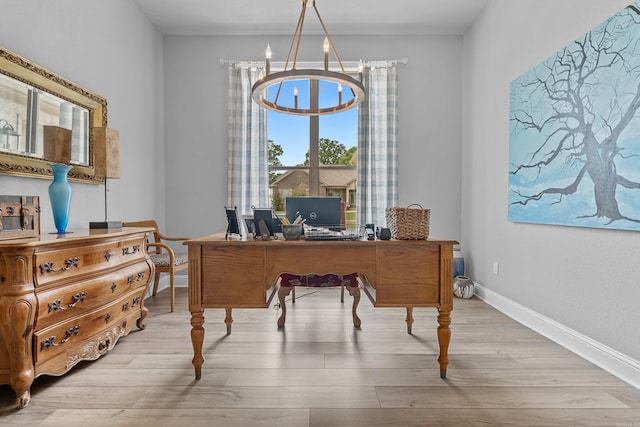 office space with a notable chandelier and light hardwood / wood-style flooring