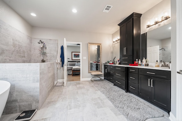 bathroom with vanity and independent shower and bath