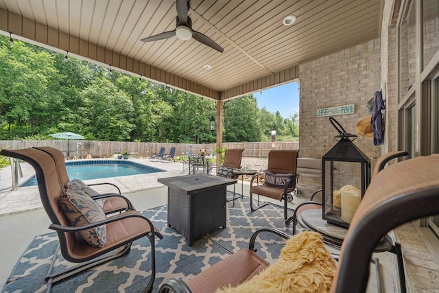 view of patio / terrace with a fenced in pool and ceiling fan