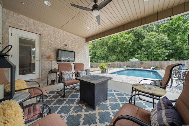 view of patio / terrace featuring a fenced in pool and ceiling fan