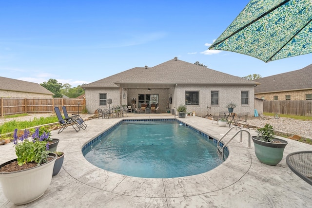 view of swimming pool with ceiling fan and a patio area