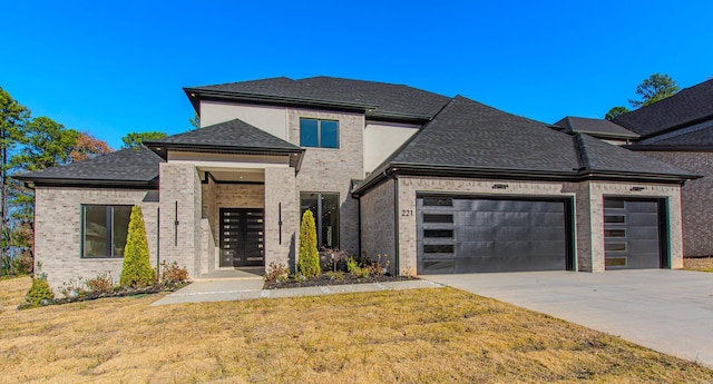 view of front of home featuring a garage and a front lawn