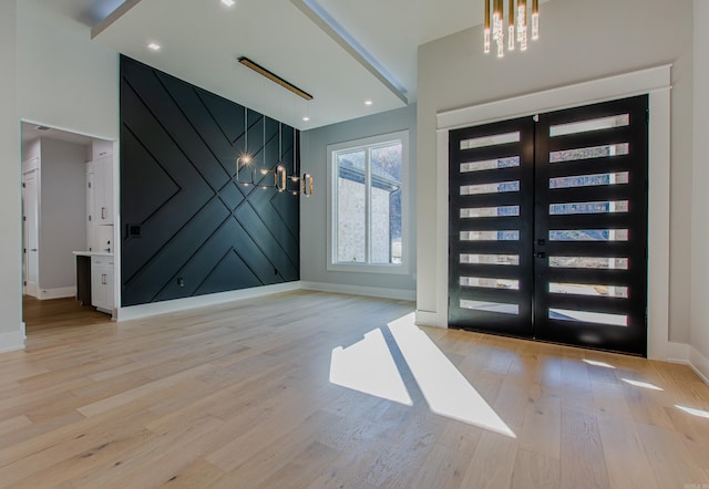 entrance foyer featuring french doors and light hardwood / wood-style flooring