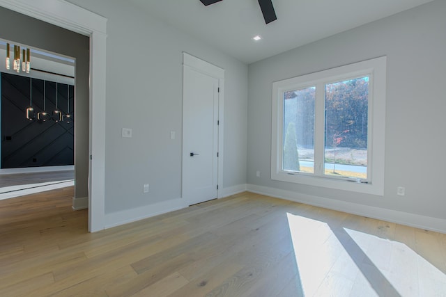 unfurnished bedroom with light hardwood / wood-style floors and ceiling fan