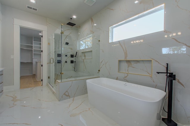 bathroom featuring shower with separate bathtub