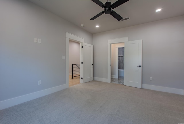 unfurnished bedroom featuring ceiling fan and light colored carpet