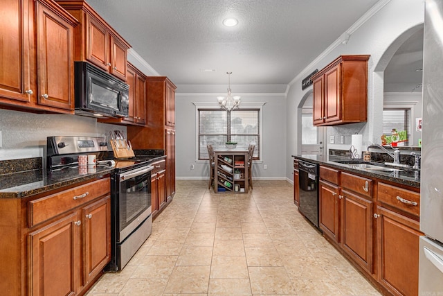 kitchen with black appliances, a notable chandelier, ornamental molding, and a wealth of natural light