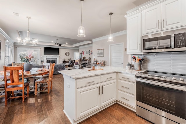 kitchen with dark hardwood / wood-style flooring, white cabinetry, hanging light fixtures, and appliances with stainless steel finishes