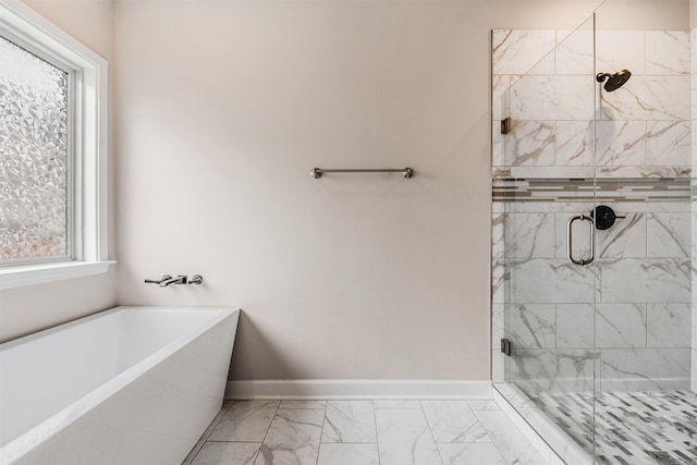 bathroom featuring separate shower and tub