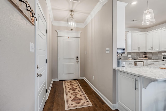 doorway featuring dark hardwood / wood-style floors, ornamental molding, and sink