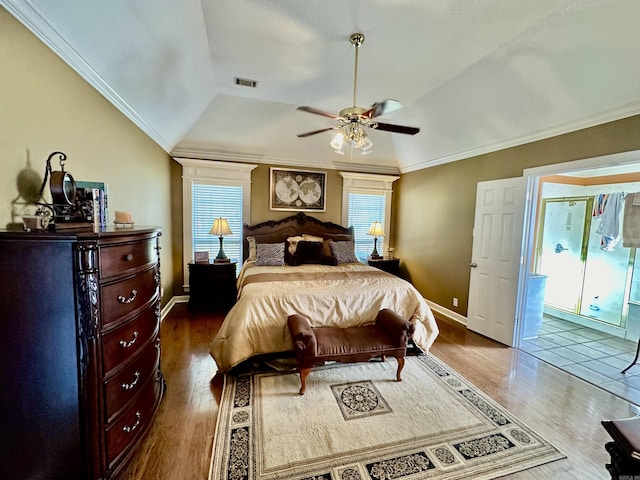 bedroom featuring dark hardwood / wood-style floors, multiple windows, and lofted ceiling