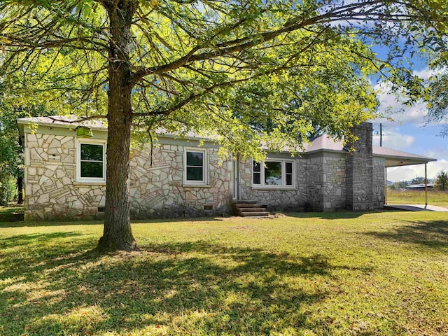 view of side of property with a yard