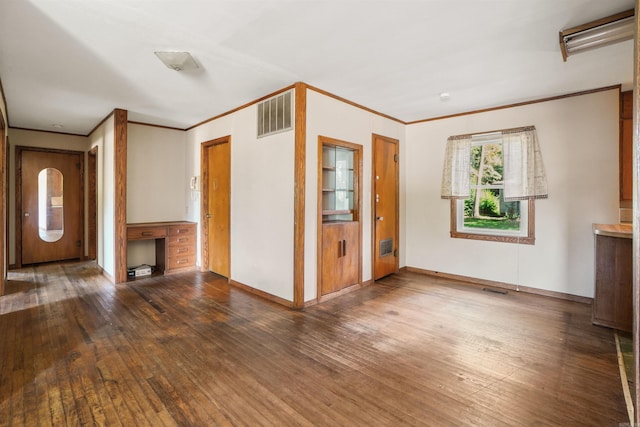 unfurnished living room with dark hardwood / wood-style flooring and ornamental molding