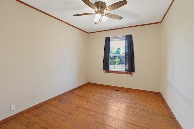 empty room featuring ceiling fan, light hardwood / wood-style floors, and ornamental molding