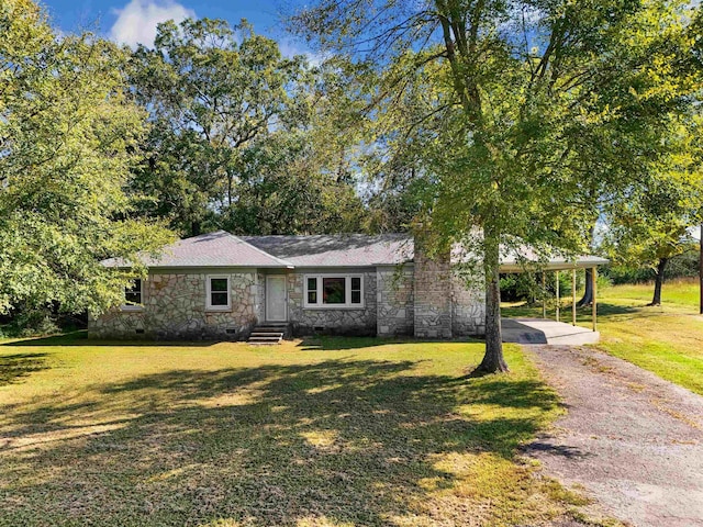 ranch-style house with a front lawn and a carport