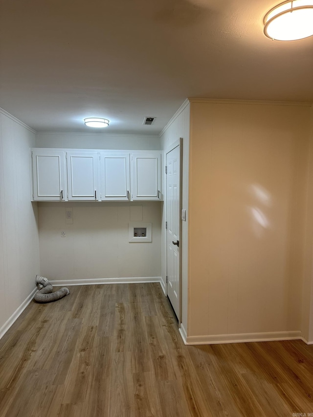 laundry area featuring cabinets, hookup for a washing machine, light hardwood / wood-style flooring, and crown molding