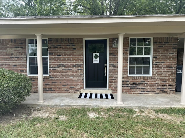 view of exterior entry with a porch