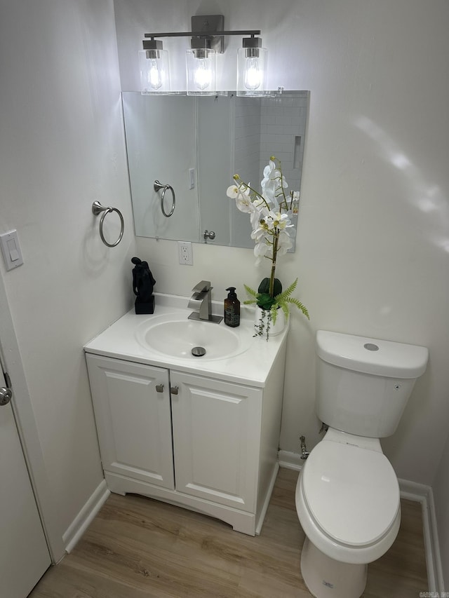 bathroom featuring hardwood / wood-style floors, vanity, and toilet