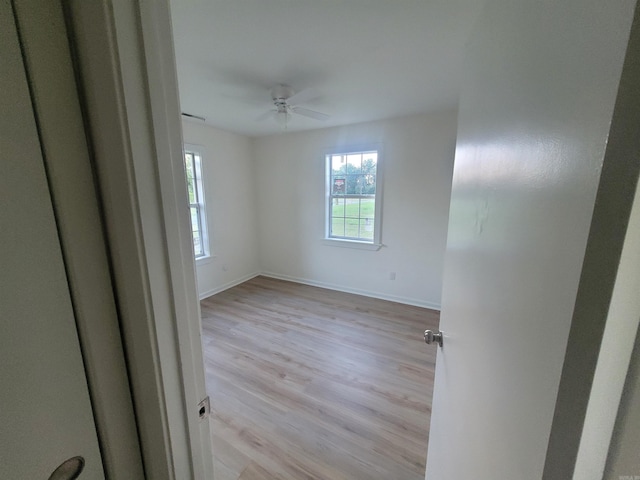 empty room featuring ceiling fan and light hardwood / wood-style floors