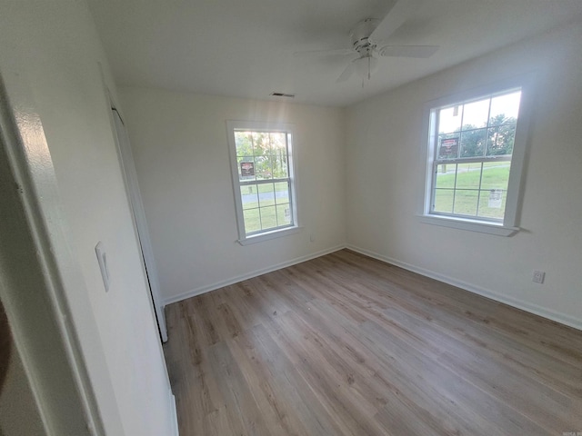 spare room with light hardwood / wood-style floors and ceiling fan