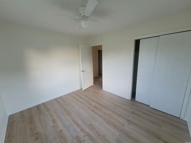 unfurnished bedroom with a closet, ceiling fan, and light hardwood / wood-style flooring