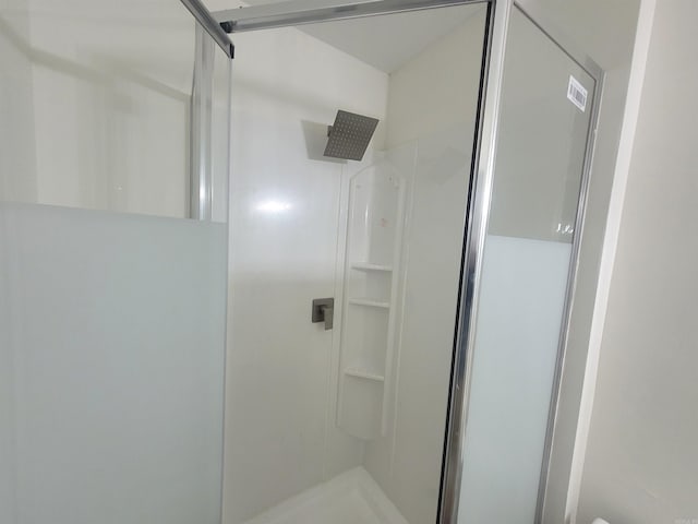 bathroom featuring a shower with shower door