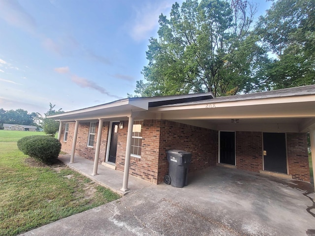 view of property exterior featuring a carport and a lawn