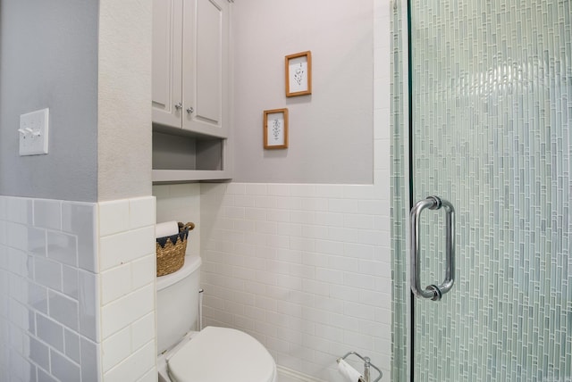 bathroom featuring an enclosed shower, tile walls, and toilet