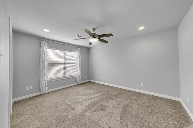 carpeted spare room featuring ceiling fan