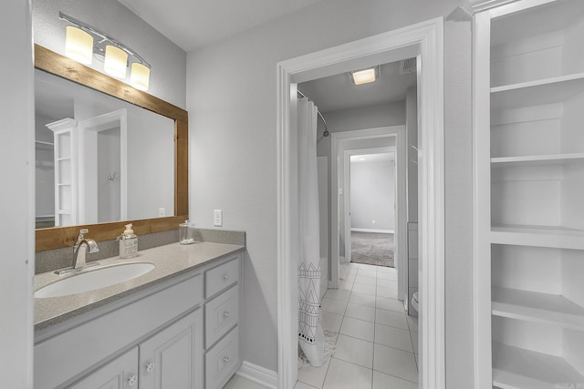 bathroom with tile patterned floors and vanity