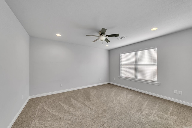 spare room featuring ceiling fan and carpet floors