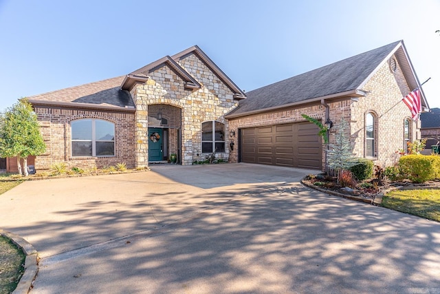 french country style house featuring a garage