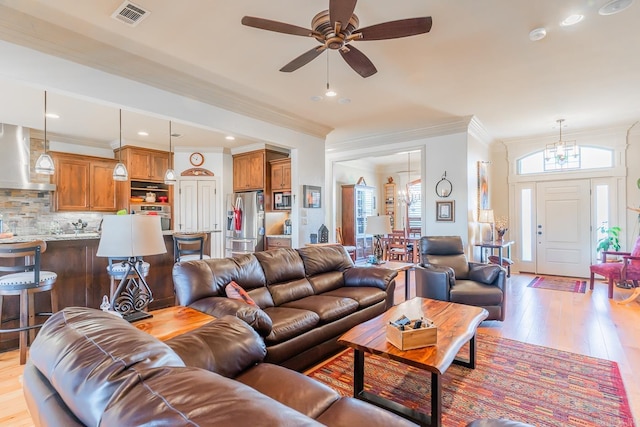 living room with ceiling fan, light hardwood / wood-style floors, and ornamental molding