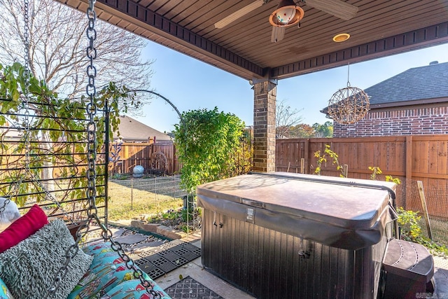 view of patio featuring a hot tub and ceiling fan