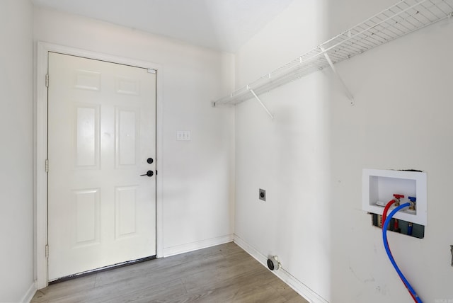 laundry room featuring electric dryer hookup, hookup for a washing machine, and light hardwood / wood-style floors